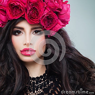 Glamorous Brunette Woman with Curly Hair and Roses Wreath Stock Photo