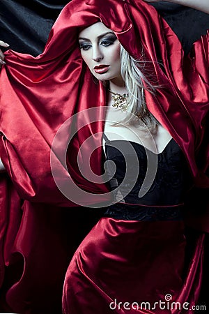 Glamorous girl in red robe Stock Photo