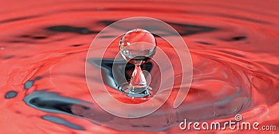 Bouncing water drops in red context Stock Photo