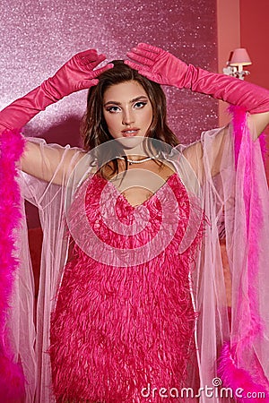 glamorous young woman in pink feathered Stock Photo