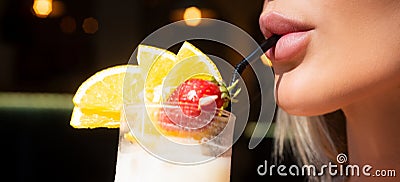 Glamour closeup of womans lips drinking cocktail with straw. Close up female sensual lips and mouth drinking cocktails Stock Photo