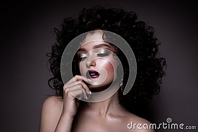 Glamour lady, Beautiful Girl on gray background. Portrait. Wavy Hair, perfect make up. Closed eyes. Stock Photo