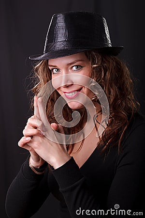 Glamour portret of beauty woman smiling in dark hat with pistol Stock Photo