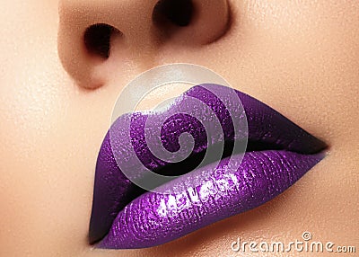 Glamour purple Gloss Lips with sensuality gesture. style, closeup macro shot female Lip Make-up. Sensuality mouth Stock Photo