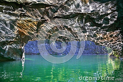 Glare of sun in cave of marble quarry Stock Photo