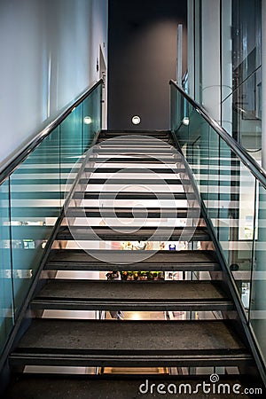 Modern glass staircase leading upward with handrail Editorial Stock Photo