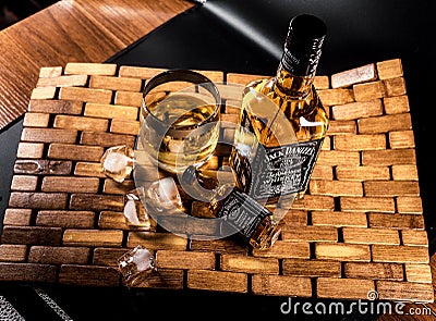A glass of alcohol and ice cubes - Jack Daniels Whiskey Editorial Stock Photo