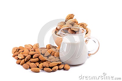 Glass of Almond milk with a heap of almonds on white background Stock Photo