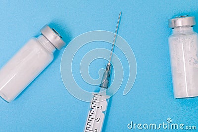 Glass ampoule with medicine and a medical syringe. White powder for injection. Antibiotic treatment of diseases. Coronavirus Stock Photo