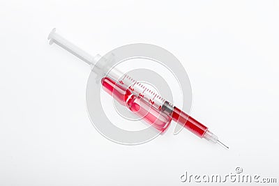 Glass ampoule with red virus vaccine with syringe. Stock Photo