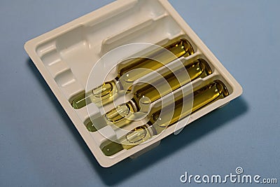Glass ampoules with medicine on a gray background. Stock Photo