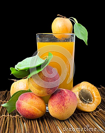 Glass apricot juice and fruits black isolated. Stock Photo