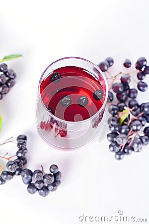 Glass of aronia juice with berries, overhead view Stock Photo