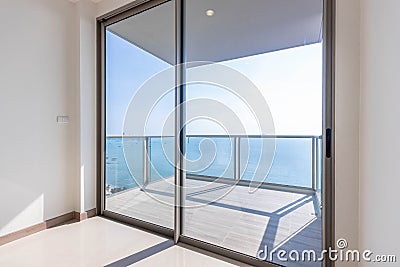 The glass balcony overlooks the sea. Stock Photo