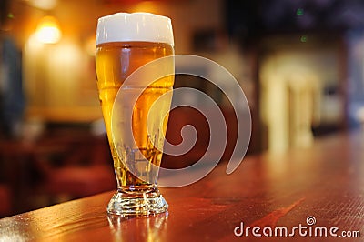 Glass of beer on the bar Stock Photo