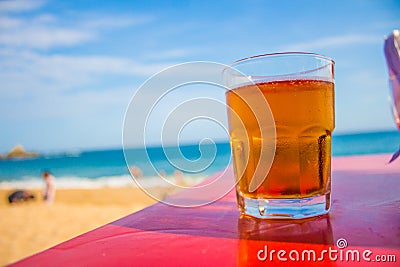 Glass of beer on the beach in Oaxaca Stock Photo