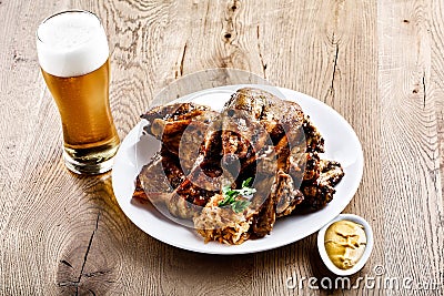 Glass of beer, chicken appetizer, sauce Stock Photo