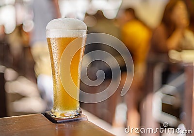 Glass of beer stands on a table in a pub. White unfiltered beer Stock Photo