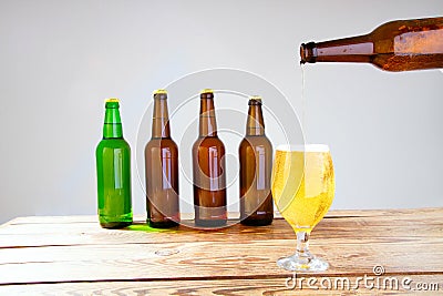 Glass of beer on wooden table, top view. Beer bottles. Selective focus. Mock up. Copy space.Template. Blank. Stock Photo