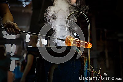 Glass blower forming piece of glass, water cooling. Stock Photo