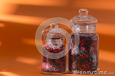 Glass boats with colored pebbles, warm world Stock Photo