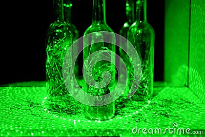 Glass bottle in laser lights. Stock Photo