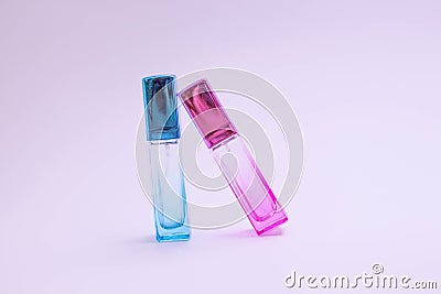 Glass bottle of perfume on white background. Pink, blue, green, black bottle. Women`s and men`s perfume. Aromatherapy, spa. Stock Photo