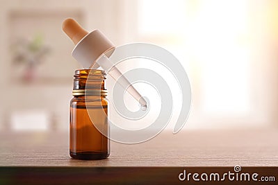 Glass bottle with pipette filled with medication for eyes room Stock Photo