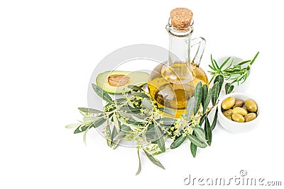 Glass bottle of premium virgin olive oil, avocado, rosemary and some olives with olive branch Stock Photo