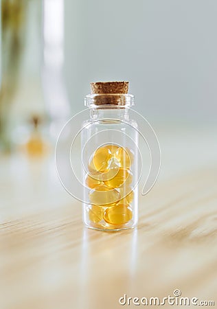 Glass bottle with softgels and Omega-3 sunlight. Stock Photo