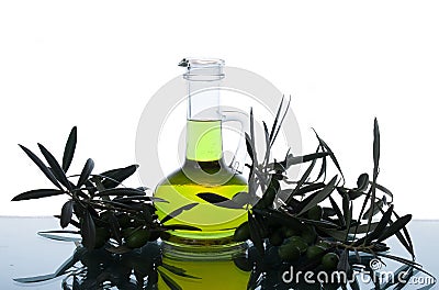 Glass bottle wtih extra virgin olive oil and olive branches. Olive tree brunch with olives Stock Photo