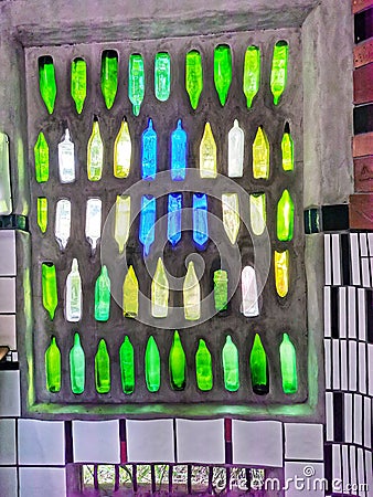 Glass bottles window in the Hundertwasser public toilet in the small town of Kawakawa on the North Island of New Zealand Stock Photo