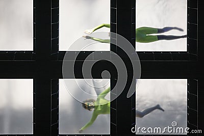 Glass bottom swimming pool with swimmers viewed from above Stock Photo