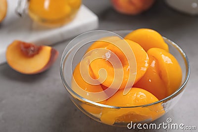 Glass bowl with conserved peach halves Stock Photo