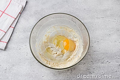 Glass bowl with dough on a gray background. Cooking greek easter orange sesame koulourakia cookies step by step Stock Photo