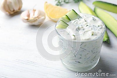 Glass bowl of Tzatziki cucumber sauce with ingredients Stock Photo