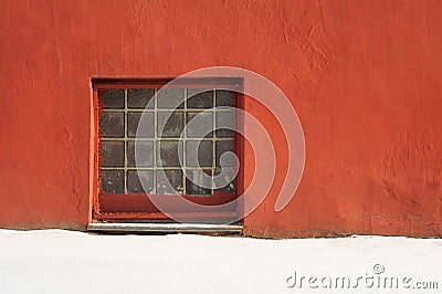 Glass brick square window in red plastered wall with copyspace Stock Photo