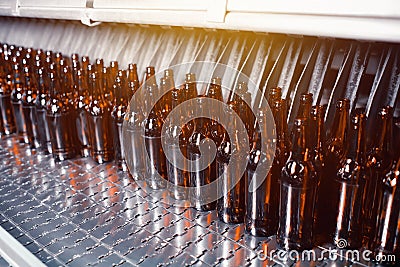 Glass brown beer bottles in industrial bottle washer. Glass brown beer Stock Photo