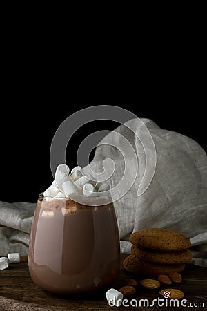 Glass of cacao, marshmallow, oat cookies and almond on cutting board Stock Photo