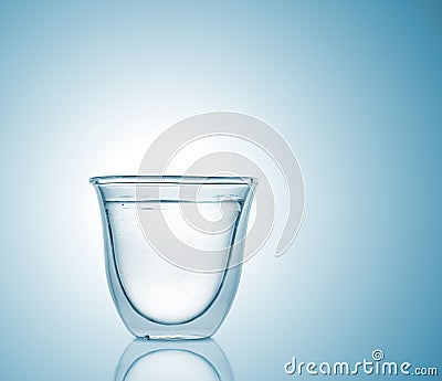 Glass with carbonated water on blue gradient background Stock Photo