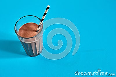 Glass of chocolate milk on blue background Stock Photo