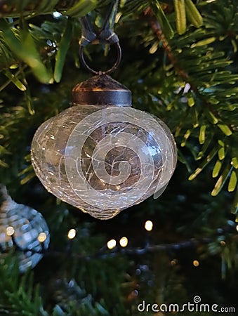 Glass Christmas bauble hanging on a pine tree Stock Photo