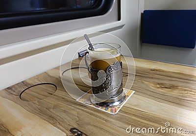 A glass of coffee in the carriage Editorial Stock Photo