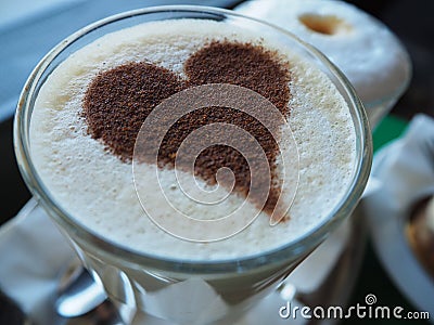 Glass of coffee latte with cinnamon heart Stock Photo