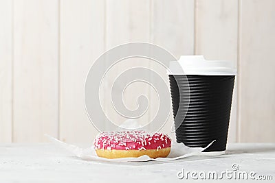 Glass with coffee and sweet tasty donut on a light background Stock Photo