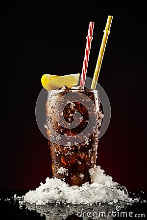 Glass cola with ice and straw. Cold glass of cola with lemon Stock Photo