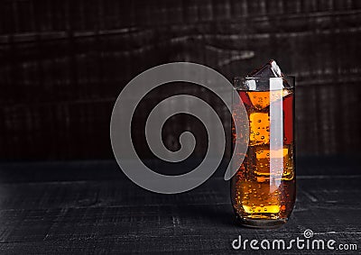 Glass of cola soda with ice cubes on wooden board Stock Photo