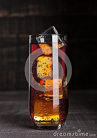 Glass of cola soda with ice cubes on wooden board Stock Photo