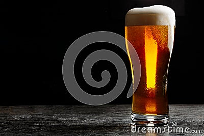 Glass of cold craft light beer on dark background Stock Photo