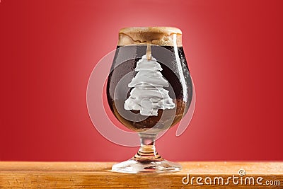 Glass of cold frothy dark beer on an old wooden table Stock Photo